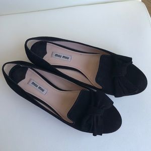 Black suede flats with sparkling heels.